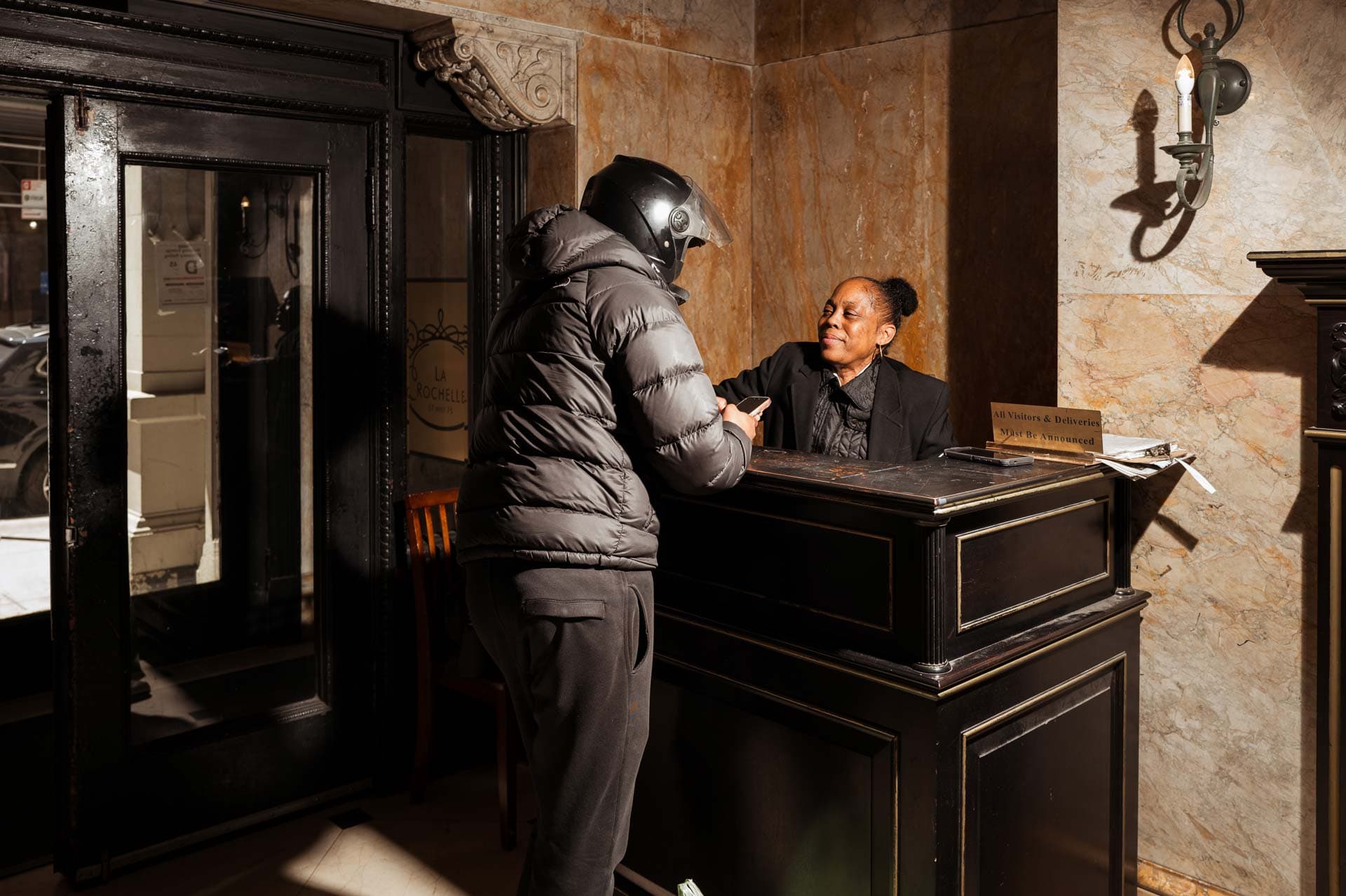 Image of a Security USA® concierge attendant receiving a delivery.