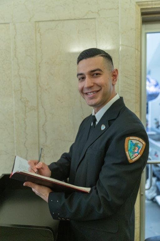 Image of a Security USA® guard writing a report.