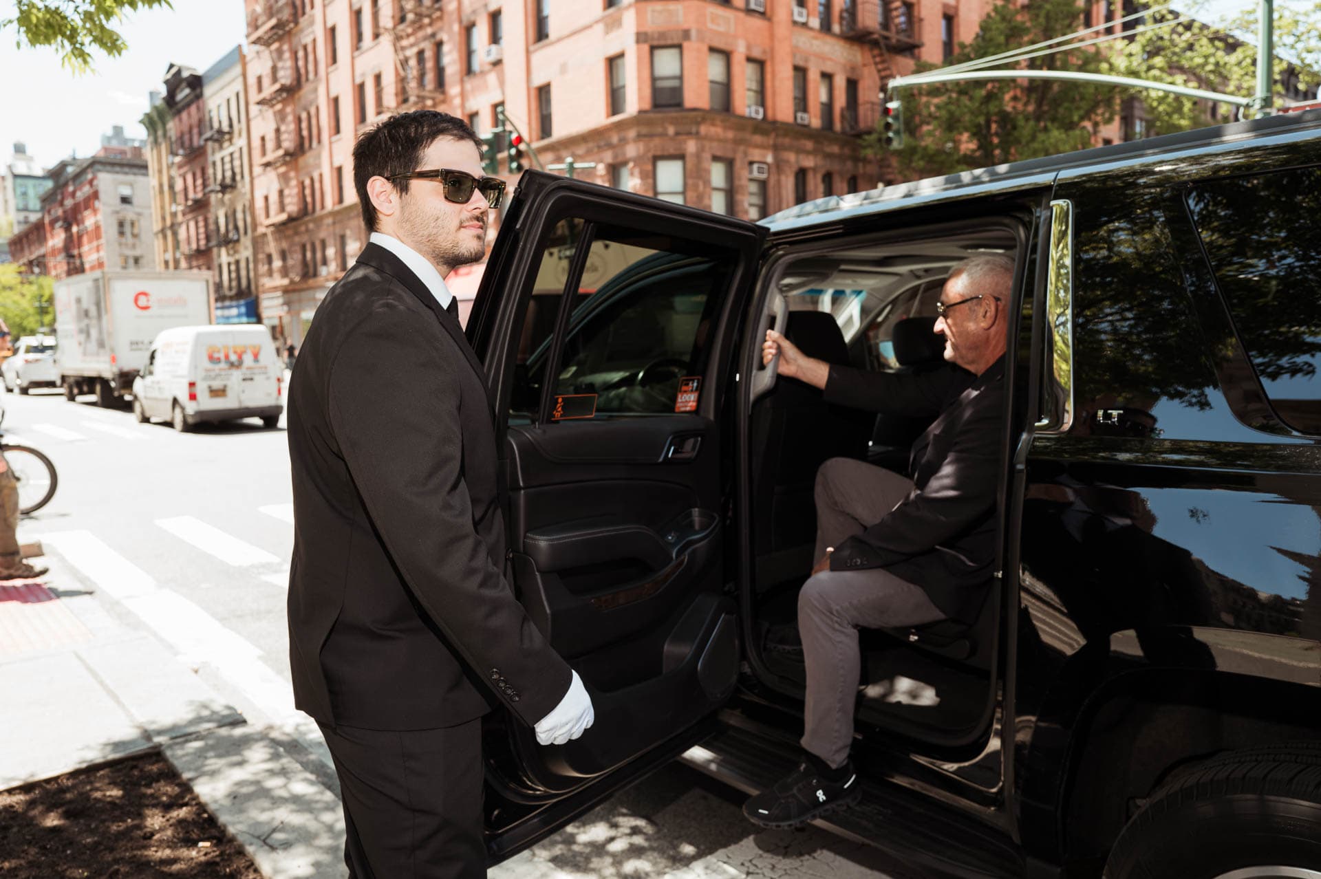 Image of a Security USA® white glove valet attendant assisting a resident into his vehicle.