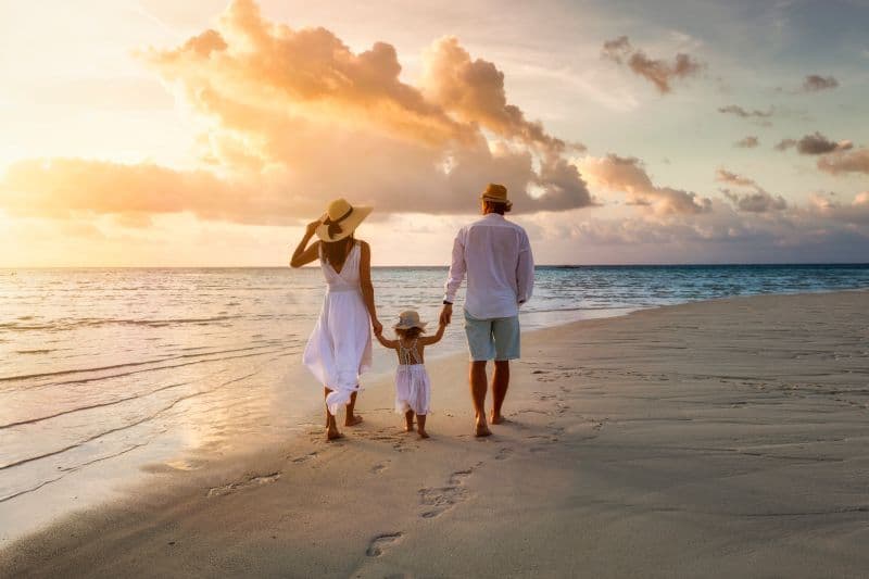 A family walking on the beach. 