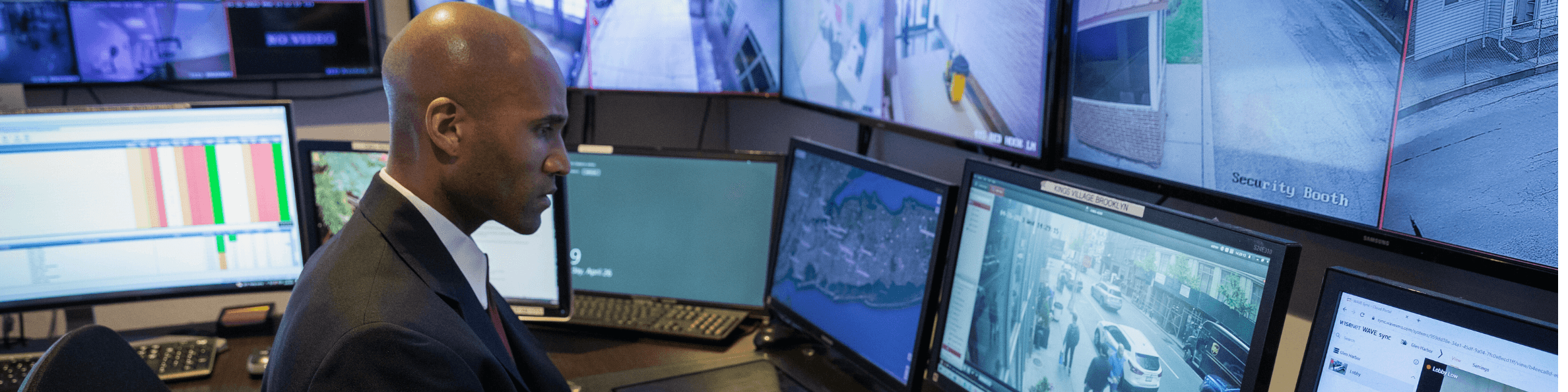 A picture of a security guard sitting at a command center