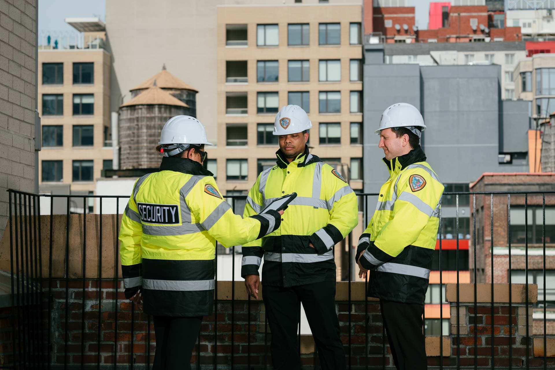 Image of far shot of 3 security guards on a roof.