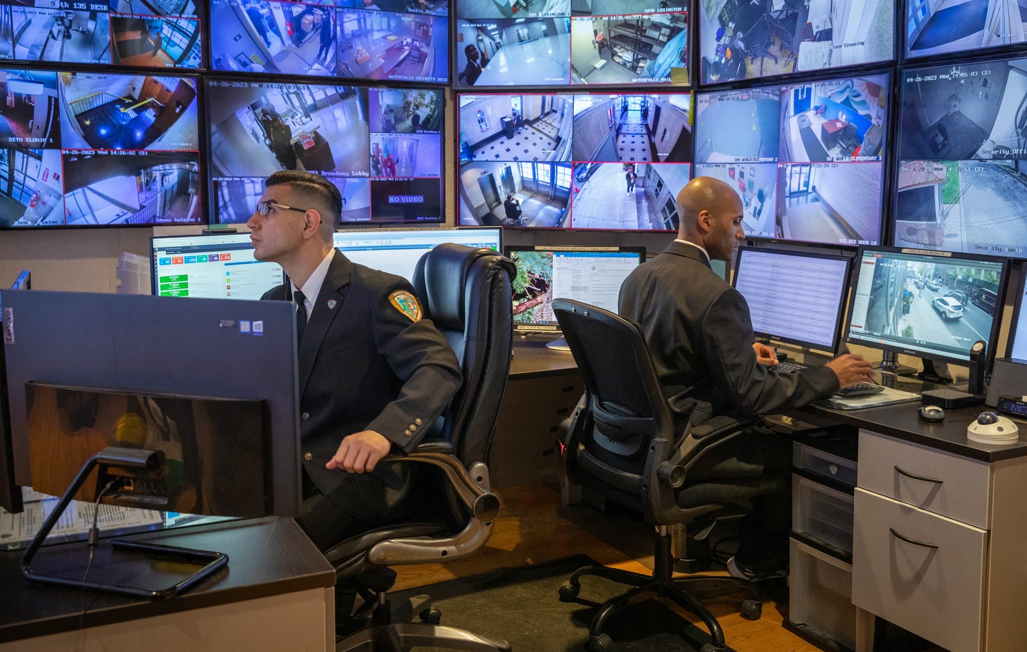 Image of two Security USA® command center specialists actively monitoring.