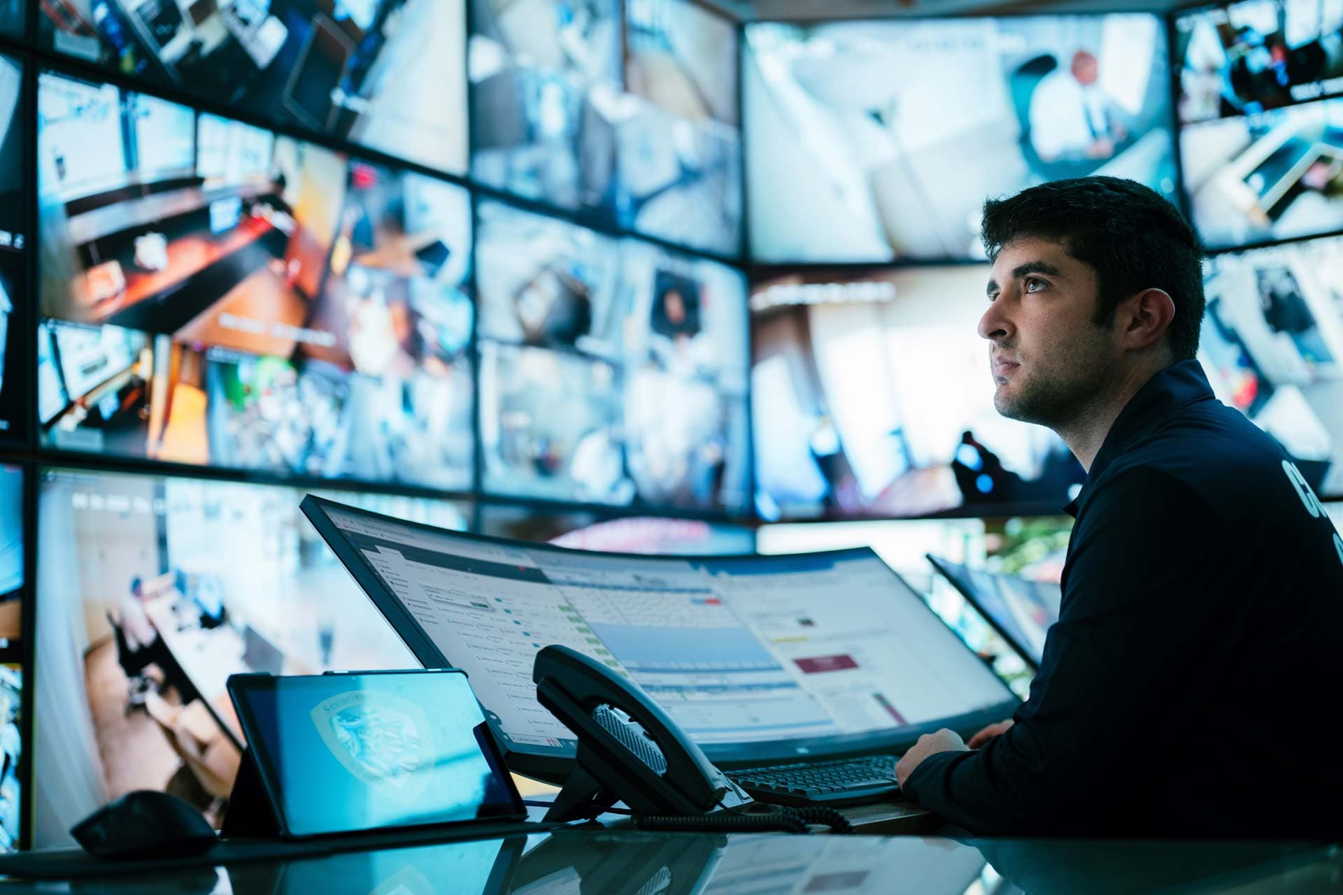 Image of data analyst monitoring in command center.