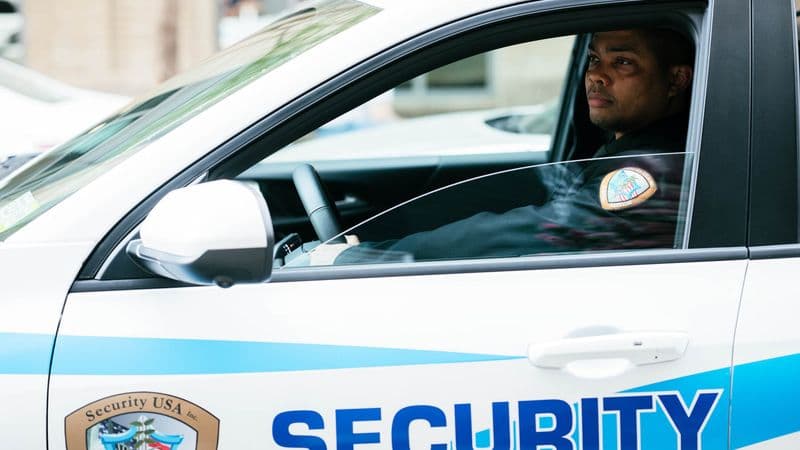 Image of guard in Security USA® patrol car.