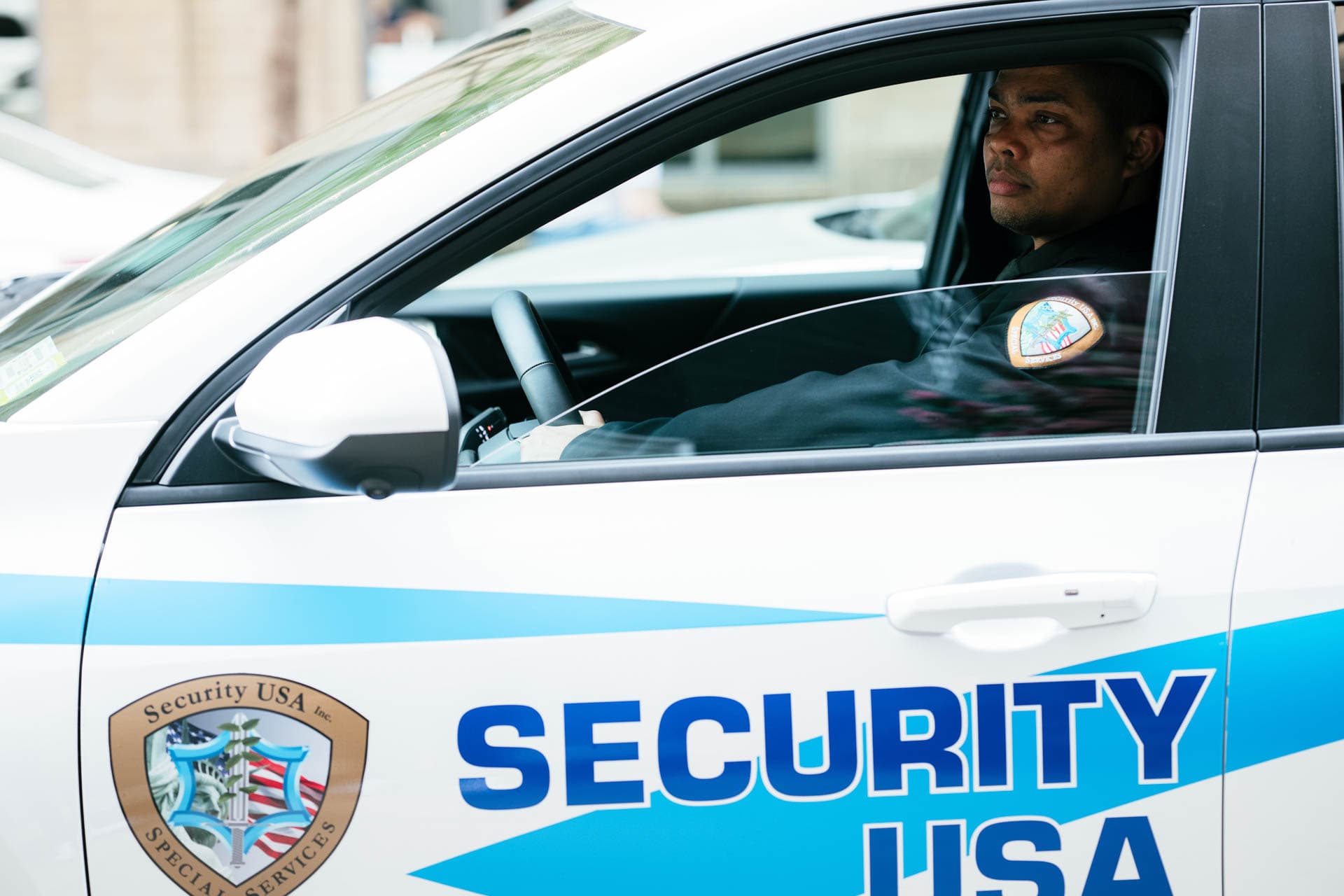 Image of guard in Security USA® patrol car.