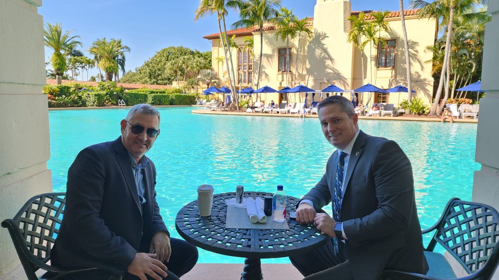 Image of Security USA® team members having a discussion by the pool. 
