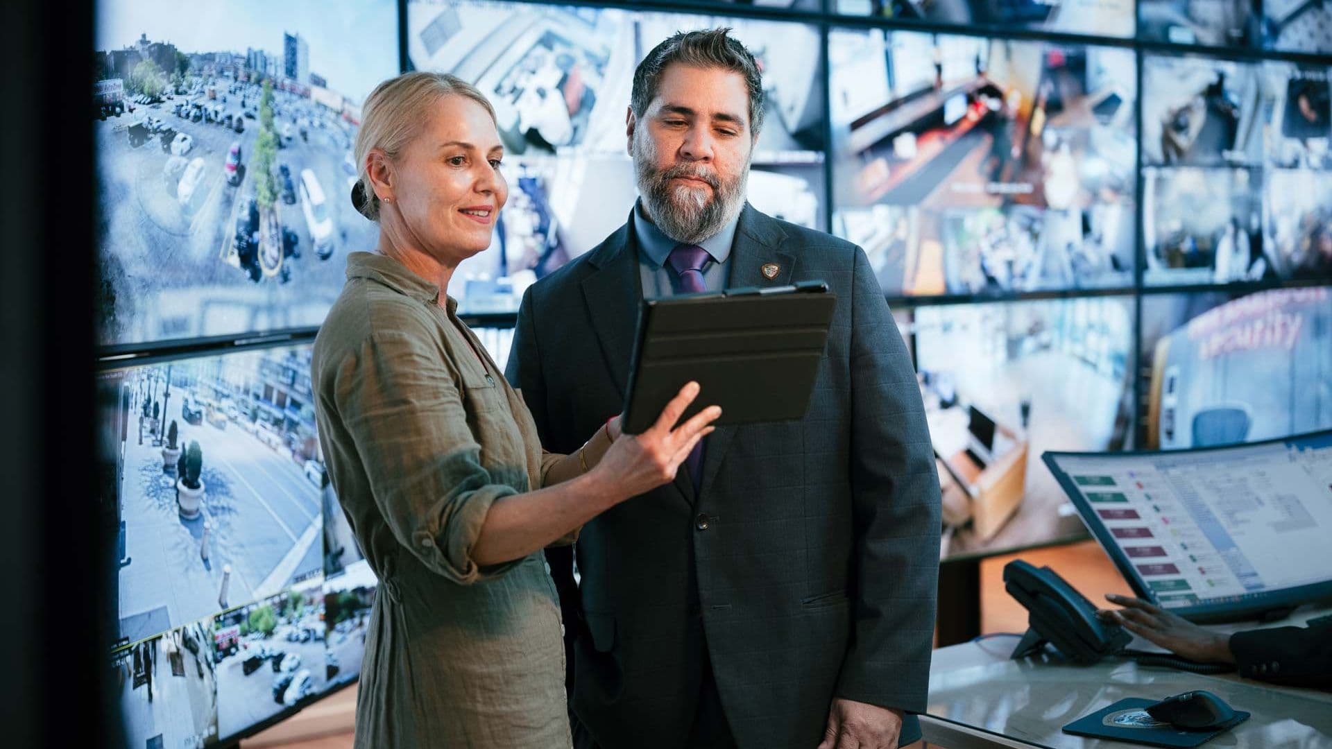 Image of property manager reviewing real time security reporting dashboard and analytics.