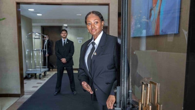Image of a Security USA® doorman and concierge standing at the front entrance of a residential building.
