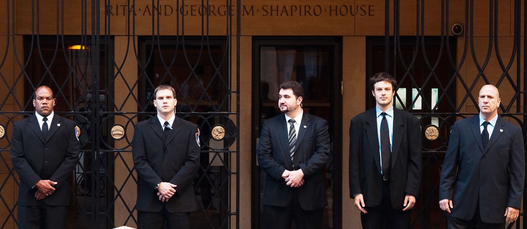 Image of Security USA® guards standing at the front entrance of a building.