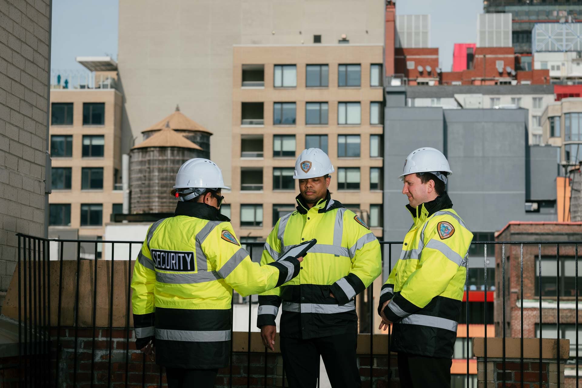 Security guards on a rooftop overlooking the city