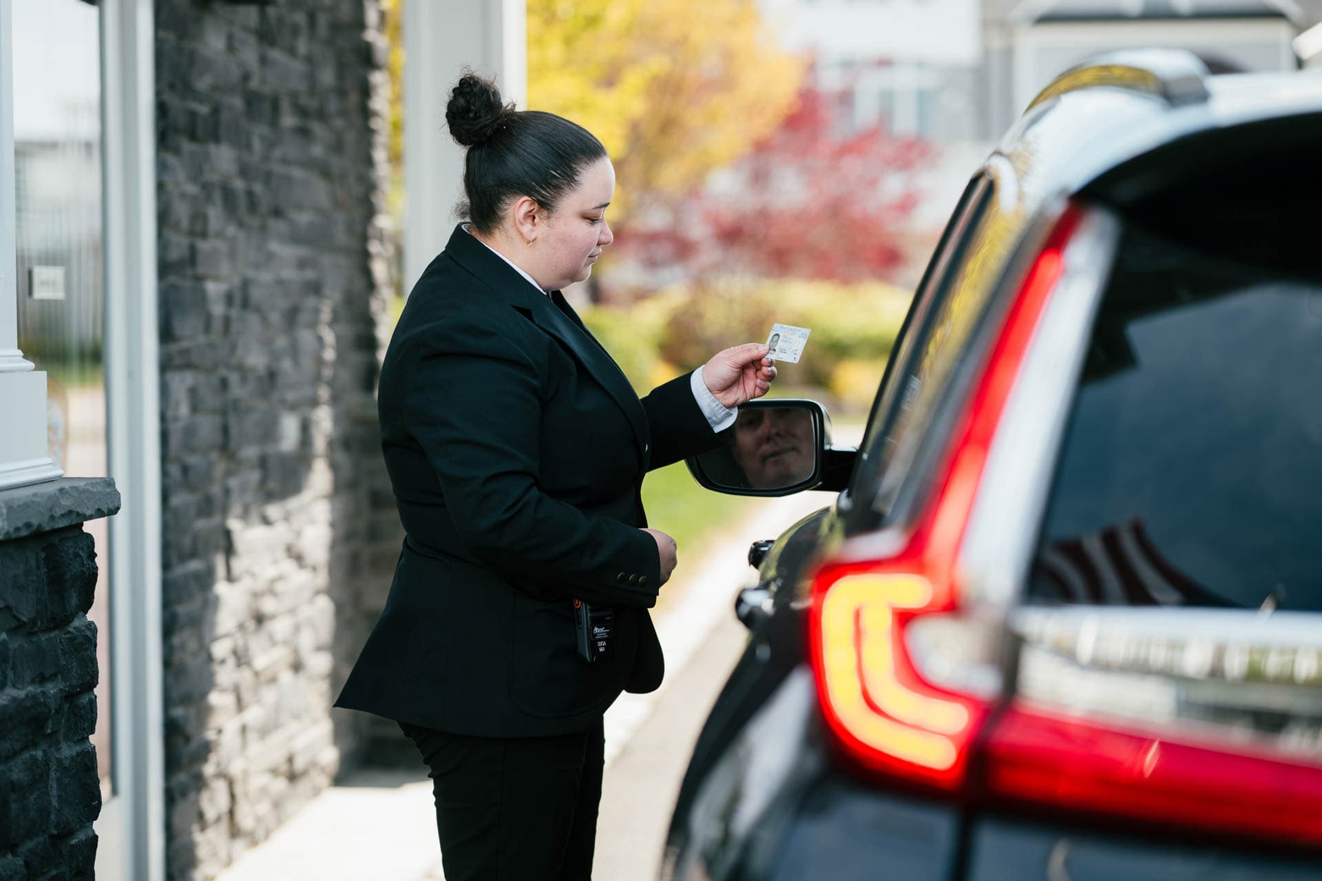 Image of a Security USA® gated community guard checking guest ID.