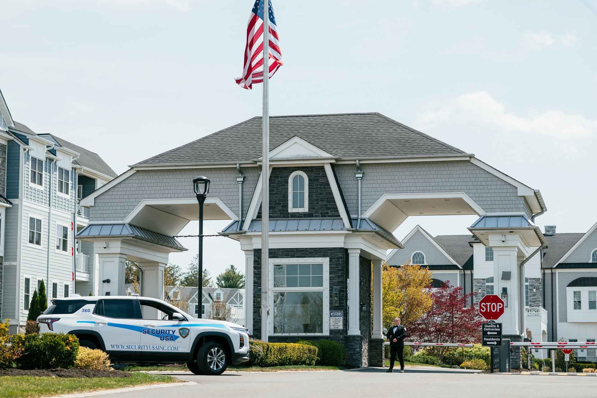 Security officer managing vehicle access at a gated community entrance