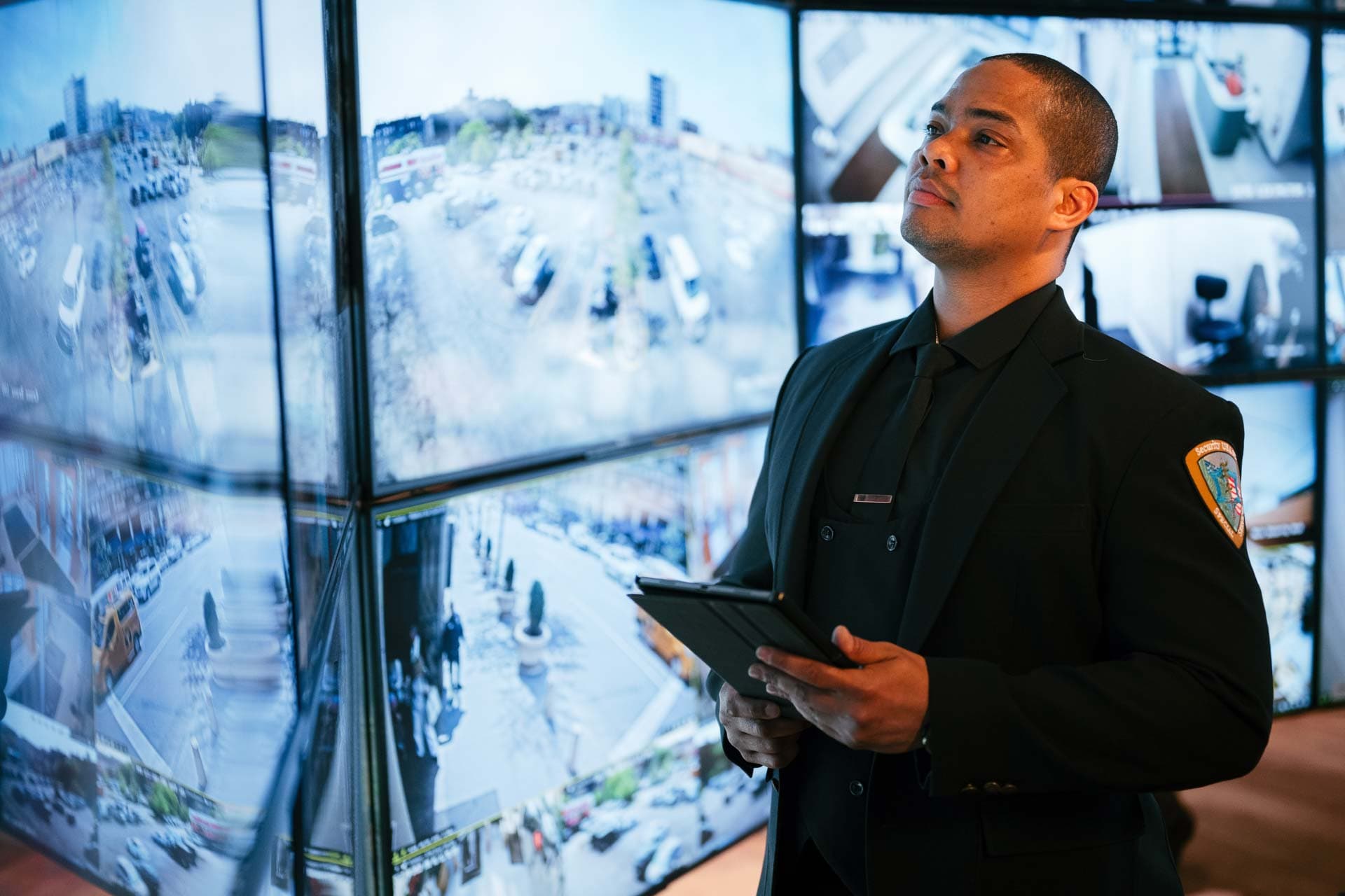 Image of a Security USA® account supervisor analyzing monitors in command center.