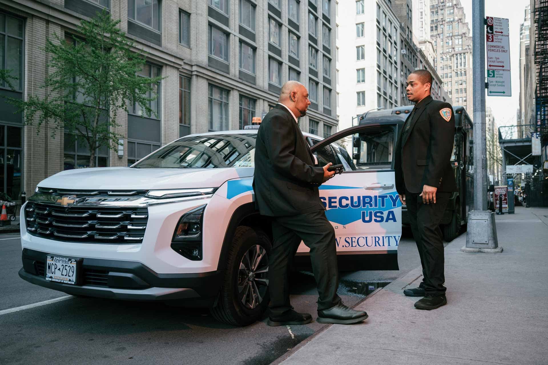 Image of Security USA® security guards with a patrol vehicle on site.