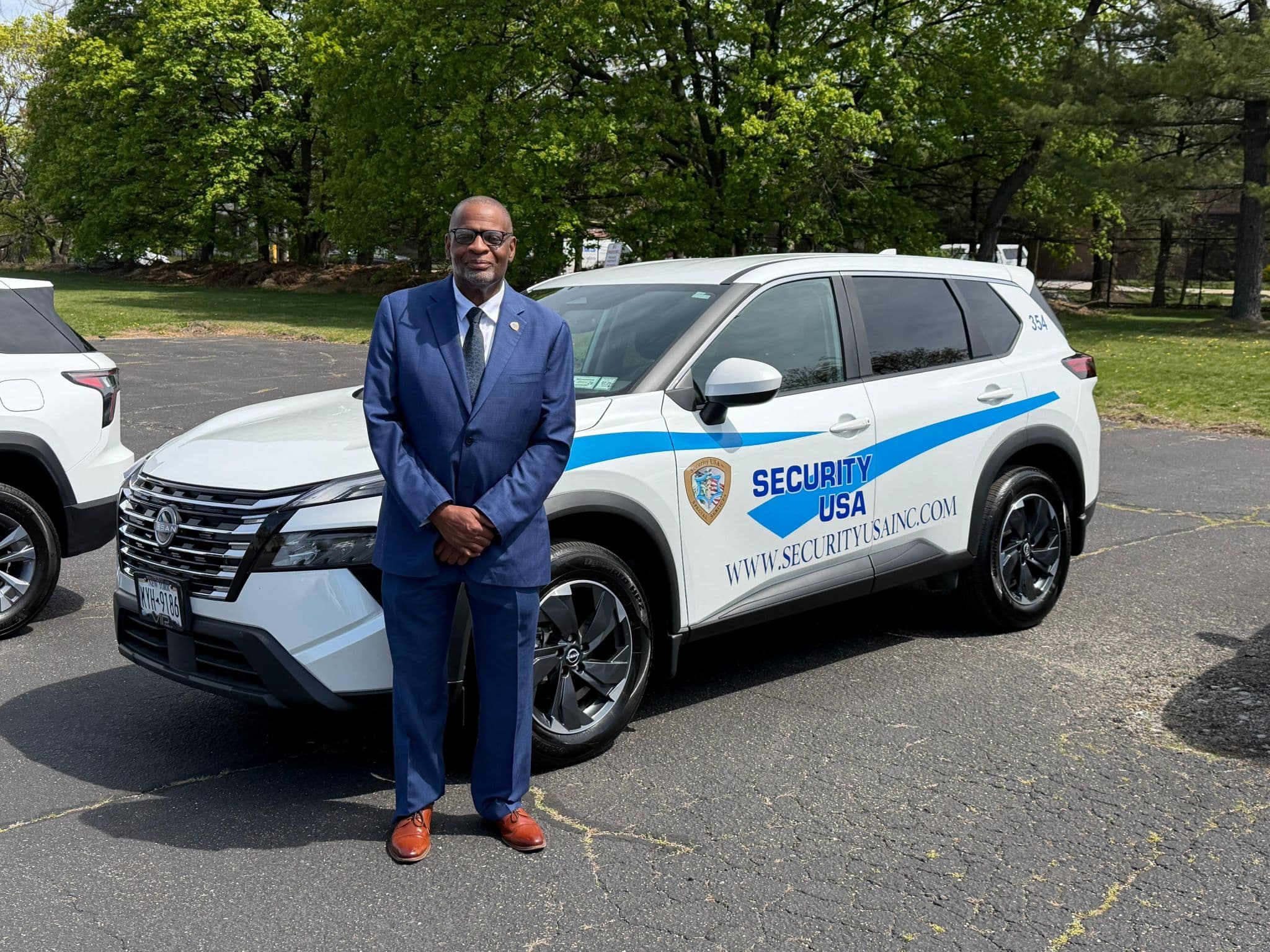 Image of Security USA® guard standing with company vehicle.