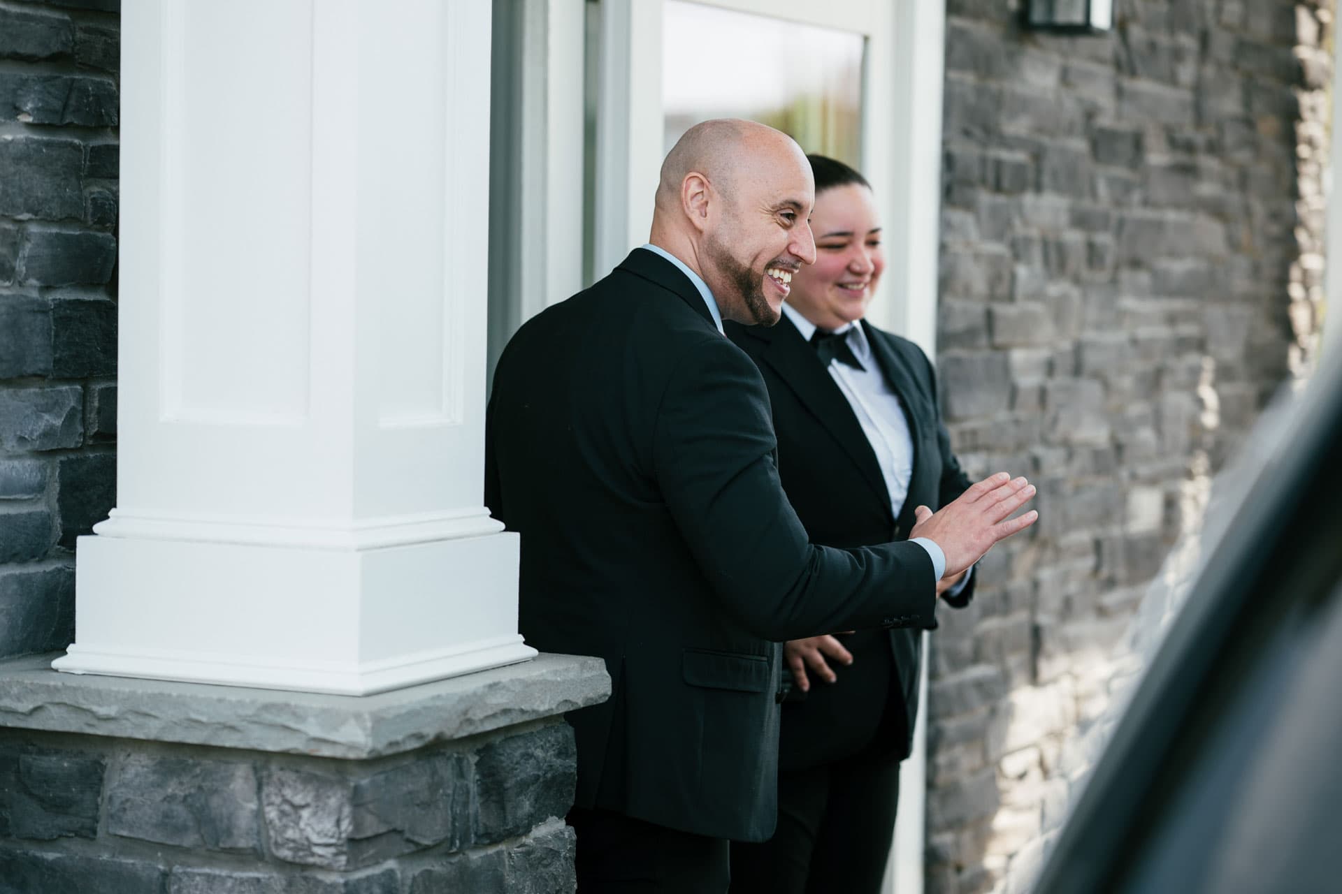Security supervisor and officer greeting a visitor at a property entrance