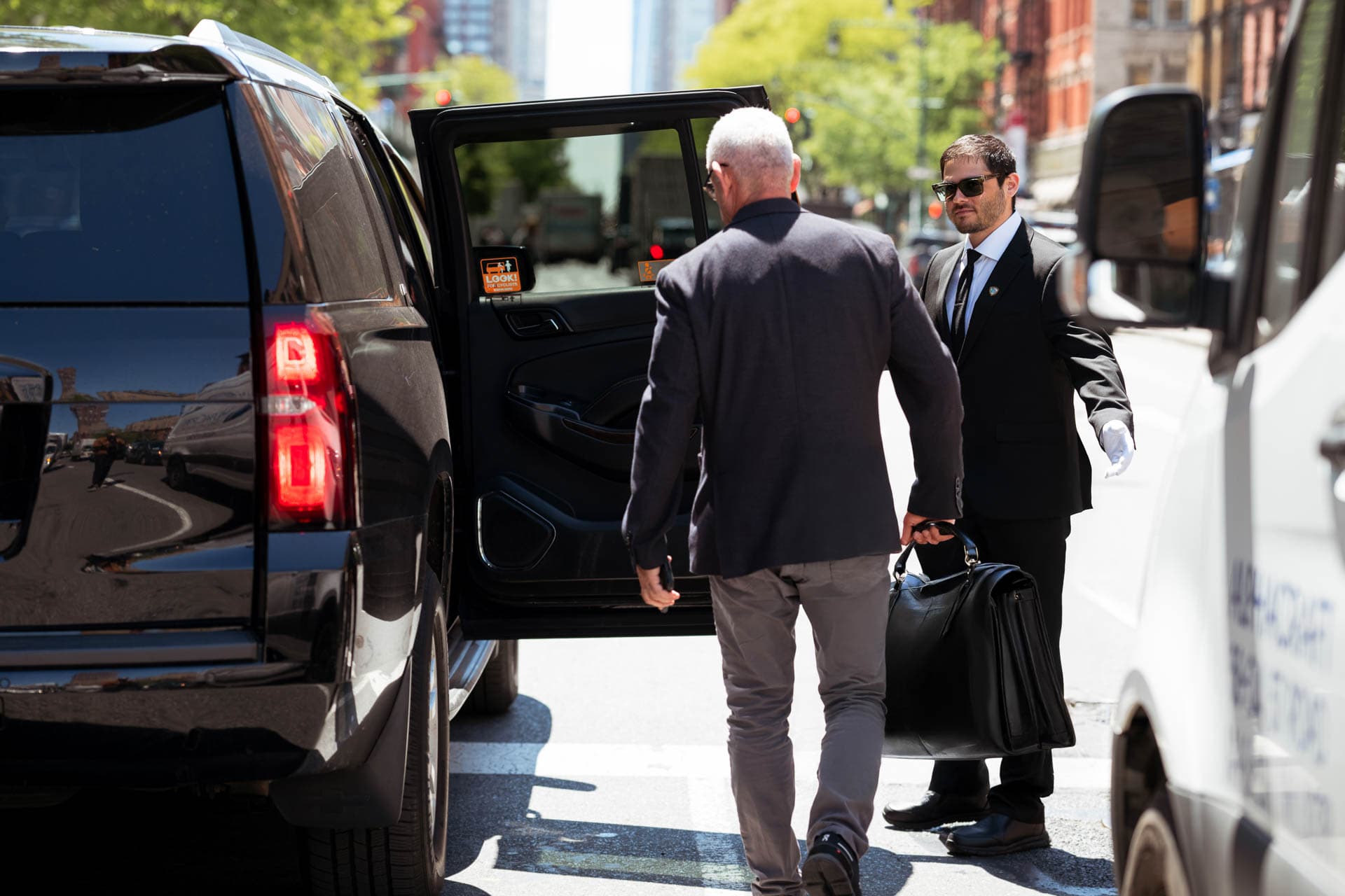 Image of a Security USA® doorman assisting resident into their vehicle.