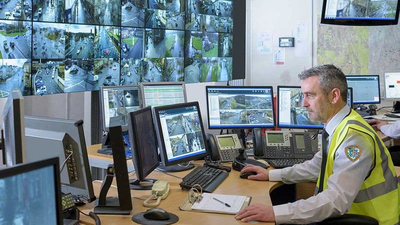 Image of a Security USA® specialist monitoring CCTV screens in a security control room.