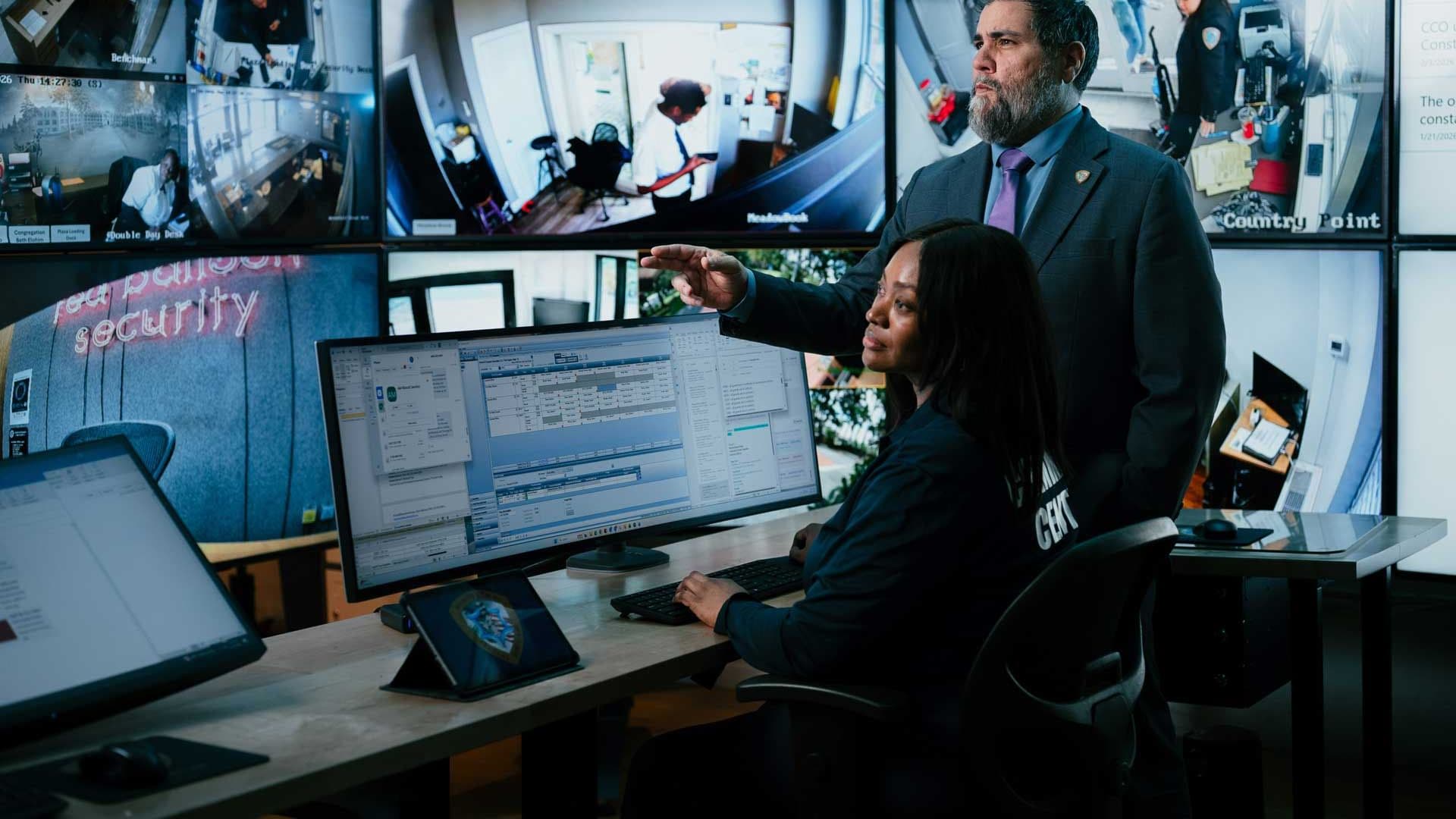 image of command center manager monitoring with female guard.