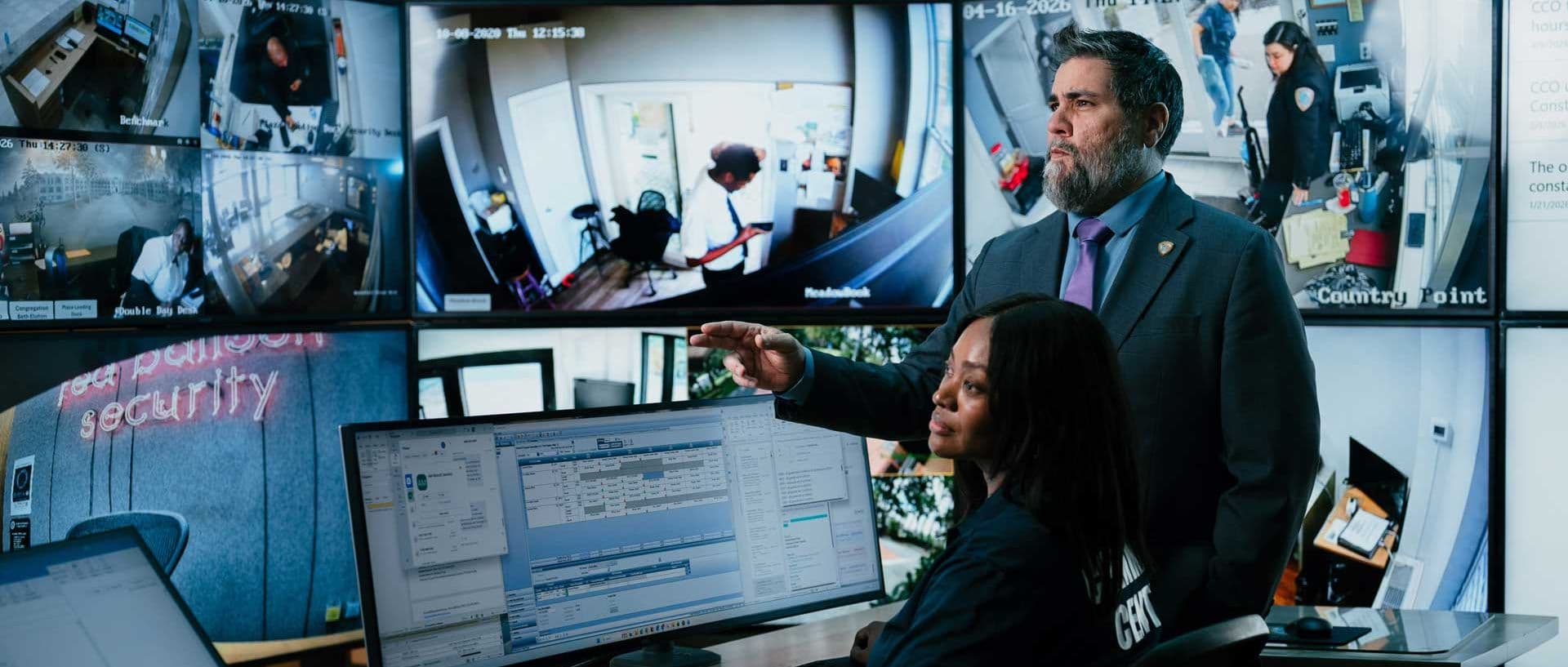 image of command center manager monitoring with female guard.