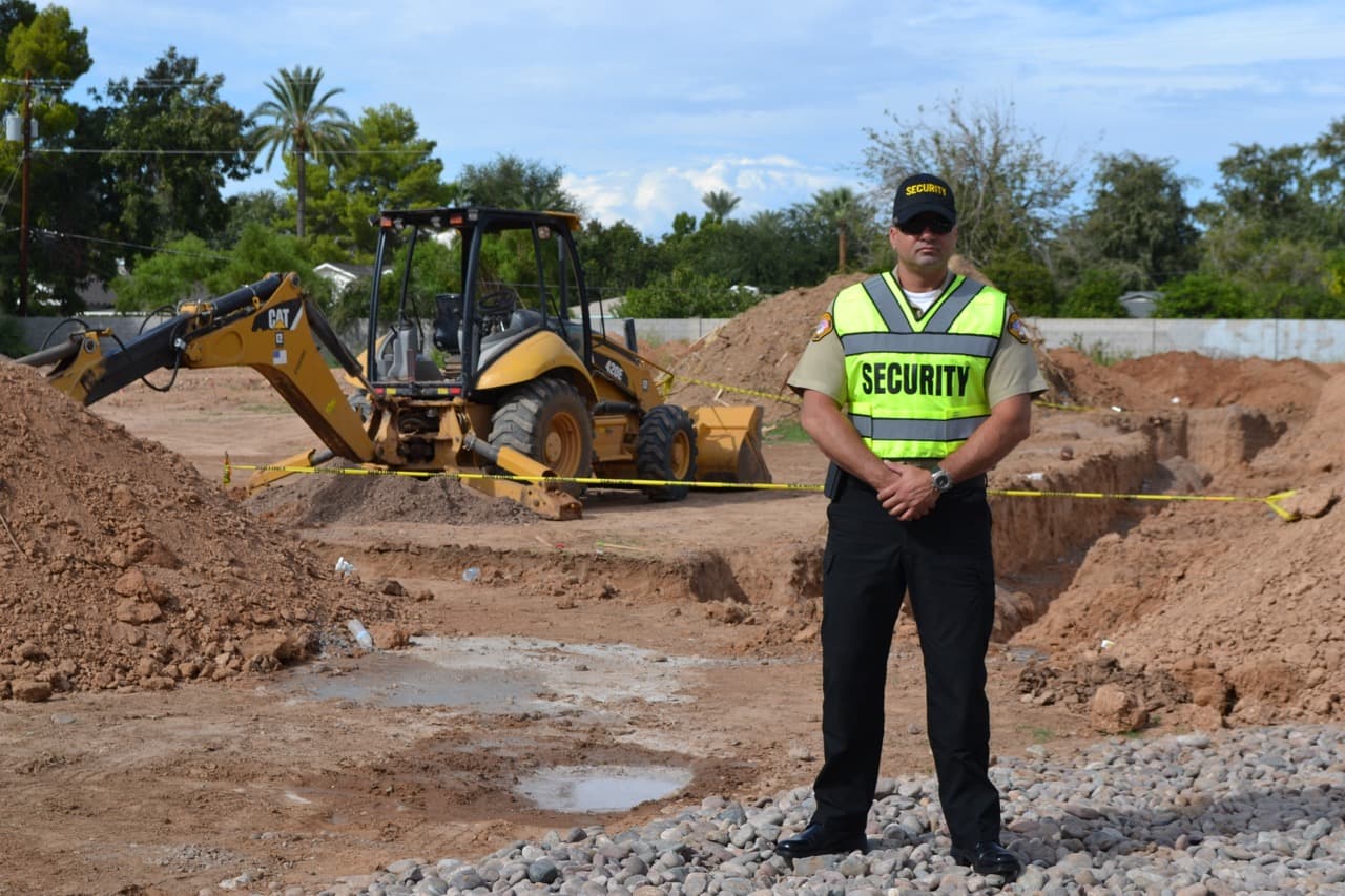 Image of a security officer monitoring access at active construction site.