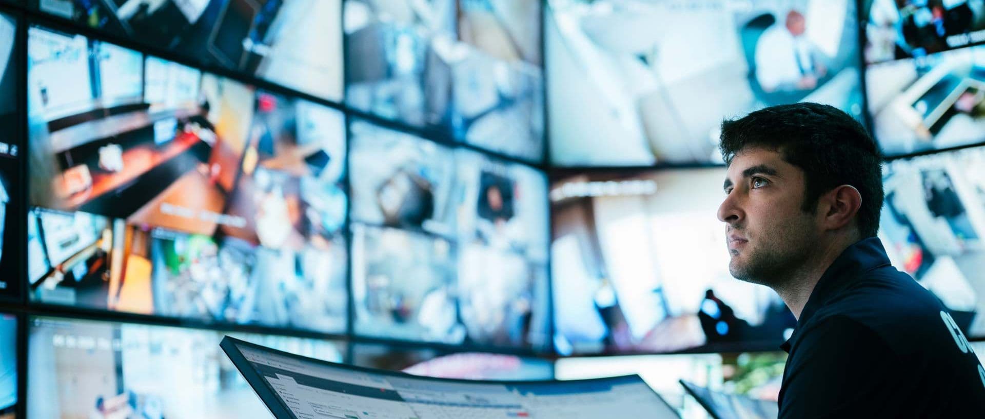 Image of data analyst monitoring in command center.