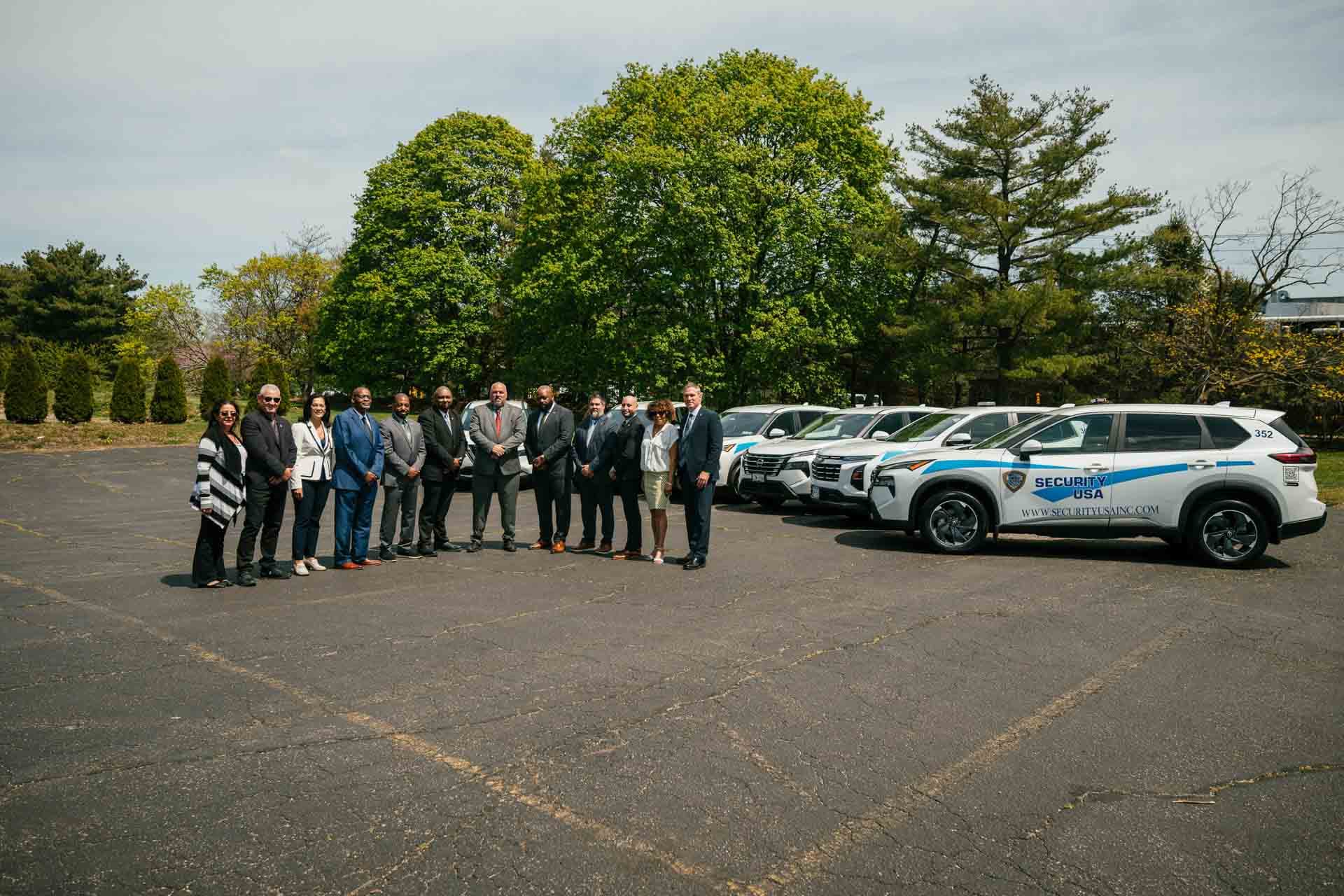 Image of executive team with Security USA® vehicles.