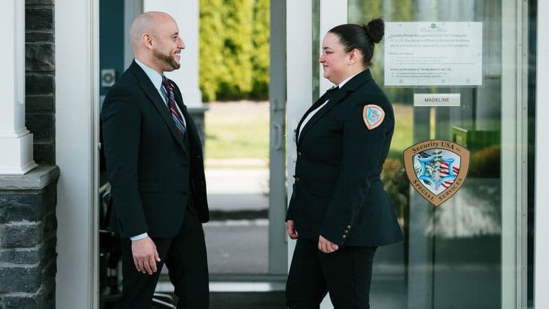 Image of security supervisor interacting with gated community security guard.