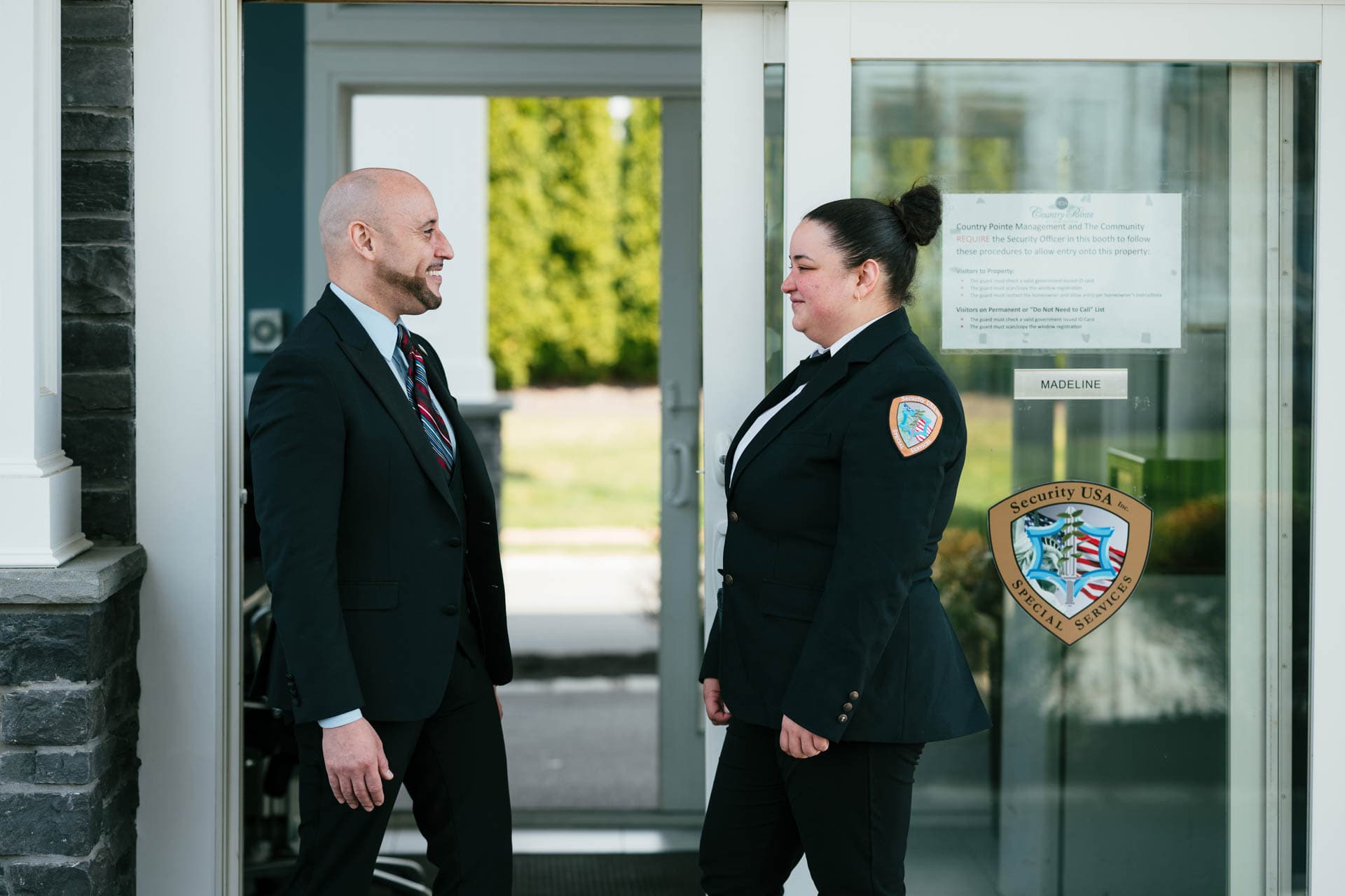Image of security supervisor interacting with gated community security guard.