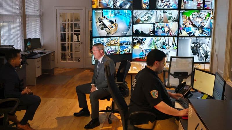 Image of a Security USA® property manager reviewing a security company proposal with a professional security consultant in a modern office setting.