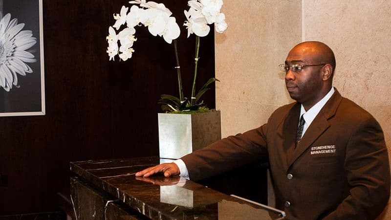 Image of a doorman behind a counter.