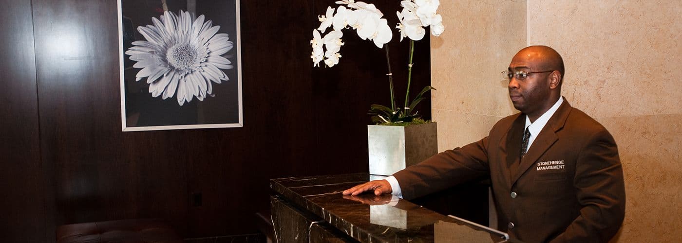 Image of a doorman behind a counter.