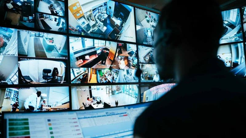 Image of close up of security guard monitoring command center.