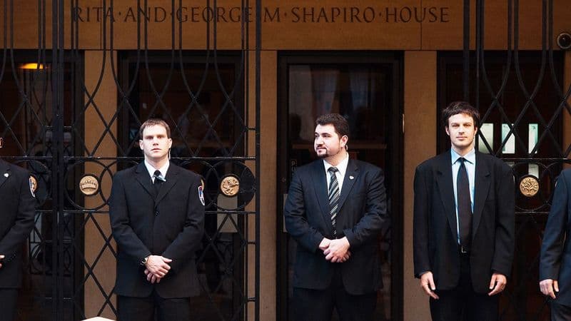 Image of Security USA® guards standing at the front entrance of a building.