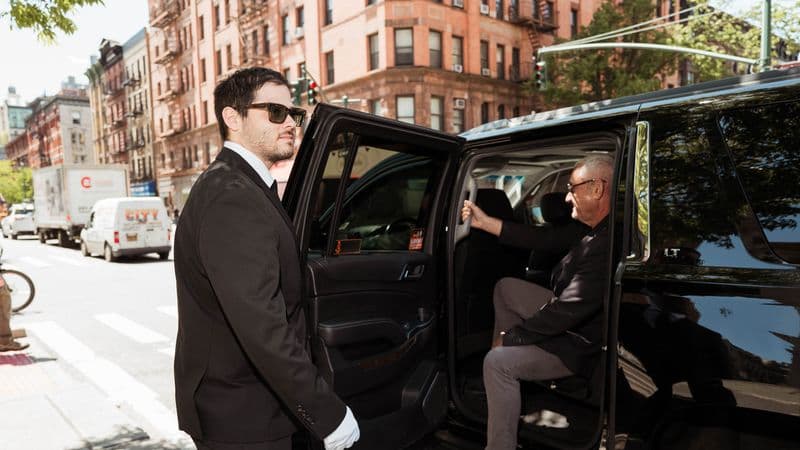 Image of a Security USA® valet attendant assisting resident into their vehicle.