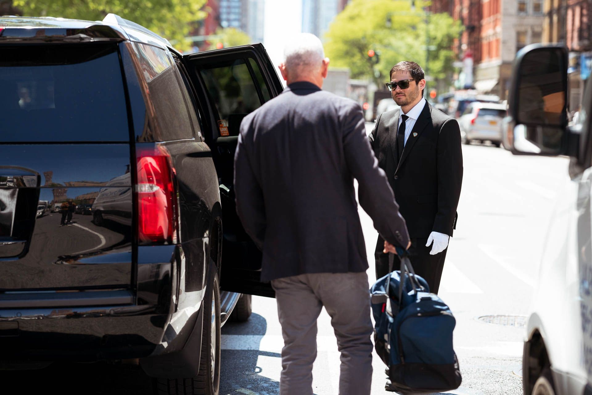 Image of a Security USA® valet attendant assisting resident into their vehicle.