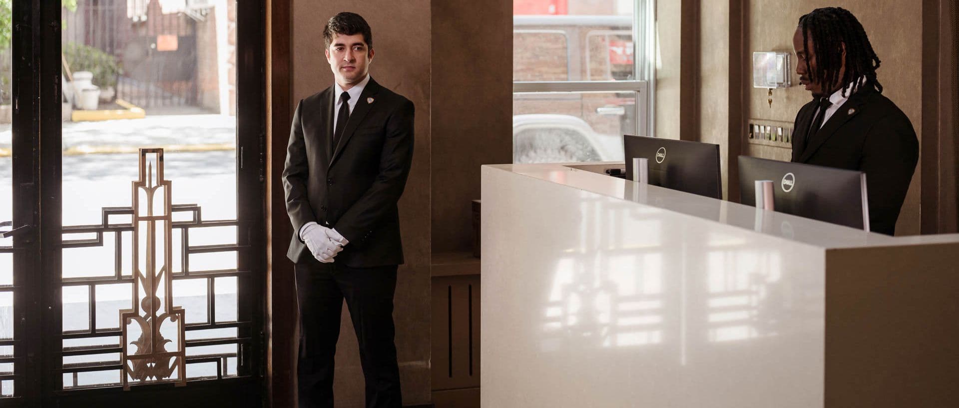 Image of white glove service with concierge in a residential building.